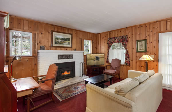 mendocino coast bed and breakfast with big river views, fireplace, red couch and queen bed