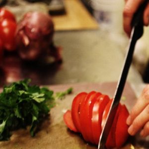 mendocino resort & hotel cooking classes - cutting tomato with knife